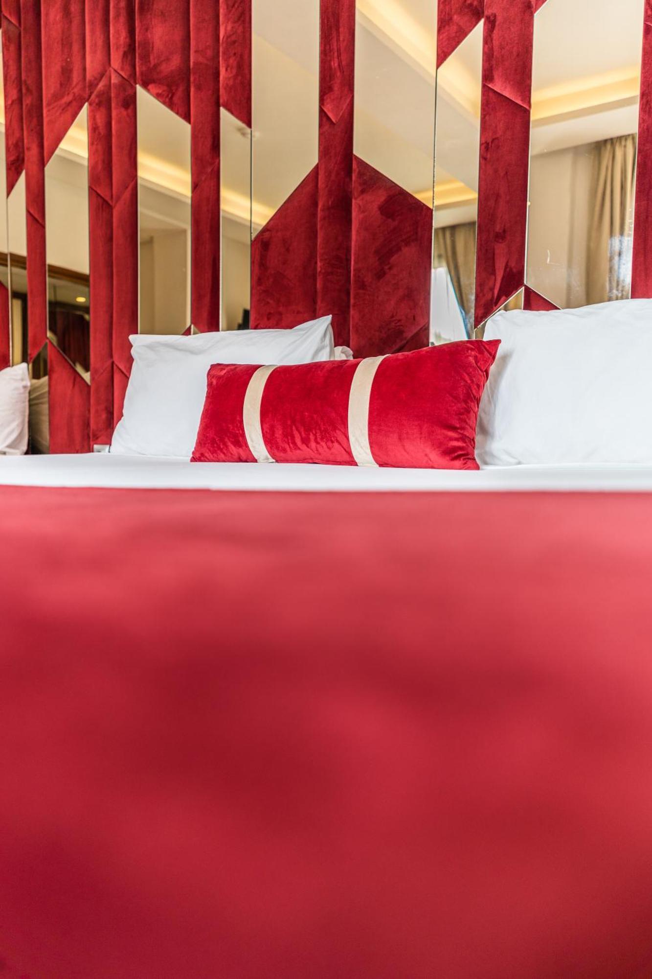 One Hotel Casablanca Exterior photo A bed with a red bedsheet